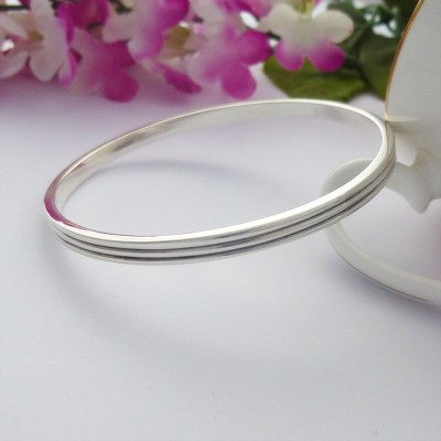 Phoebe large sterling silver bangle personalised interior and two grooves around the outside Phoebe large sterling silver bangle personalised interior and two grooves around the outside