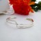 Torque bangle with crossover in sterling silver