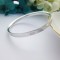 Harlow silver bangle featuring exterior hallmarks Harlow silver bangle featuring exterior hallmarks