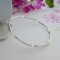 Round bangle with twisted design Round bangle with twisted design